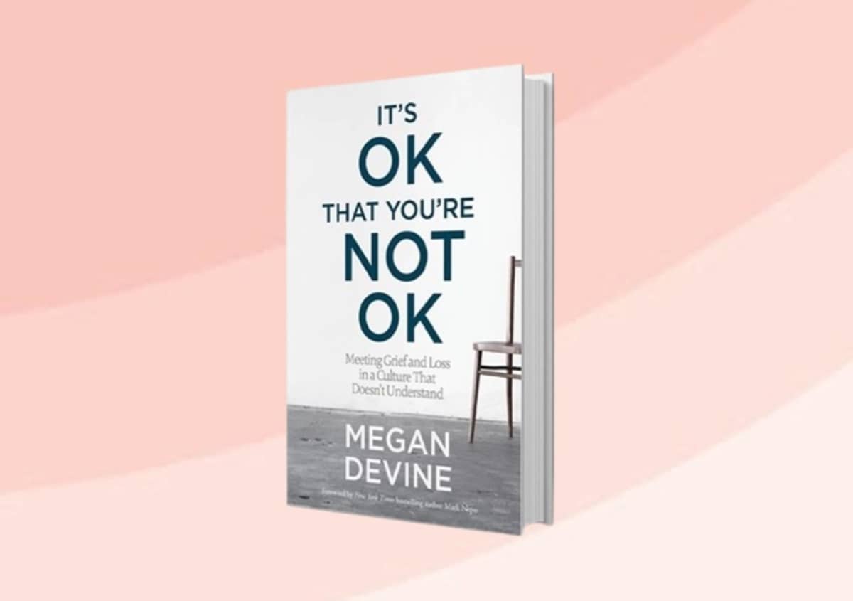 A book titled "It's ok that you're not ok" by Megan Devine
