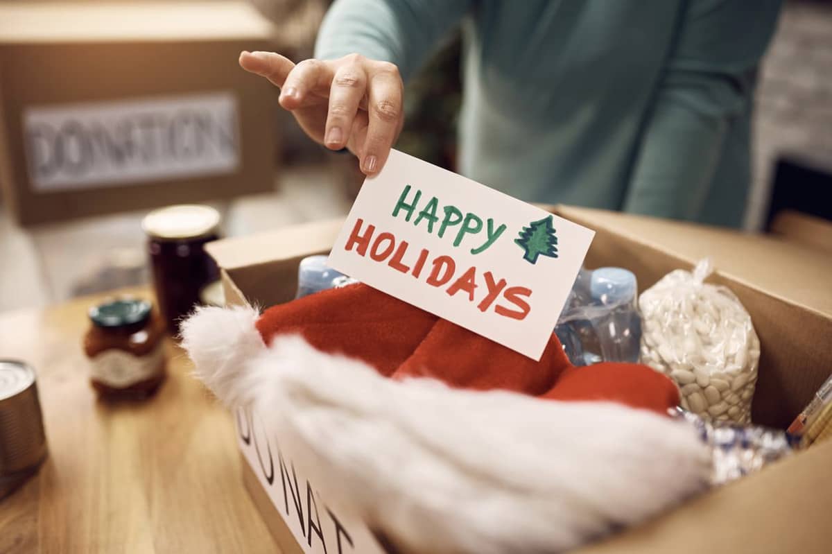 A donation box that has a card that says "Happy Holidays" inside it